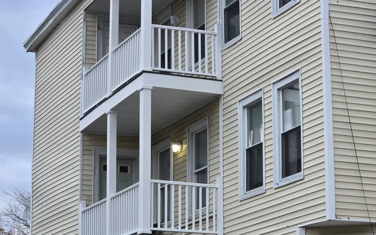 Wood exterior stairs and deck on a multi-family home in Fitchburg, Massachusetts